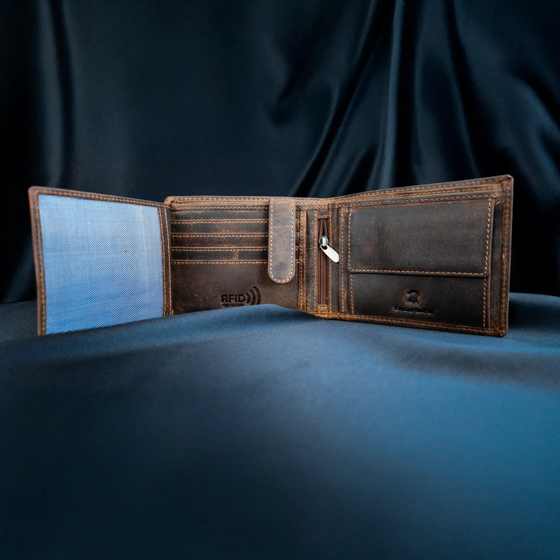 Personalized brown leather wallet for men open to show card slots and zippered pocket on dark fabric background